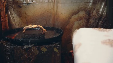 Close up man hand dipping cap in wax Stock Footage 90667099