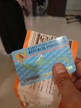 Close up of man hand hold train ticket and indonesia identity card or ktp Stock Photos