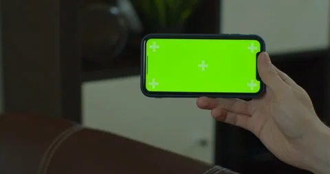 Close up of a man hand holding a mobile telephone with a vertical green screen Stock Footage 130240968