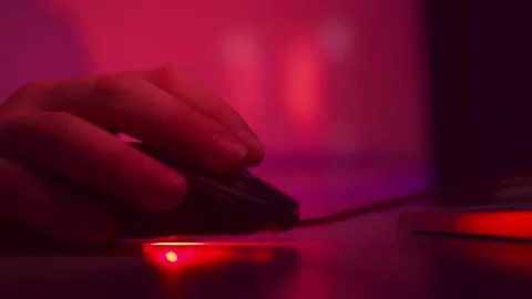 Close-up man hand holds a computer mouse, clicks on buttons, multicolored Stock Footage 150562425