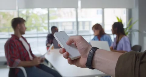 Close up of man hand holds remote control close window blinds in office Stock Footage 155847213