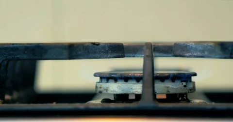 Close-up a man hand includes a gas hob in the home kitchen. 4K. Stock Footage 81715393