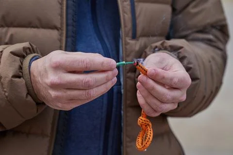 Close up of man hand lighting up a firecrackers with wick Stock Photos