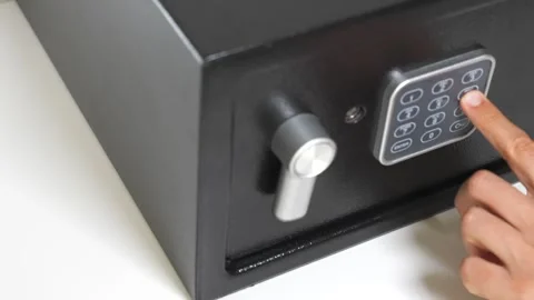 Close up of a man hand open a digital combination lock of a black steel safe box Stock Footage 260234183