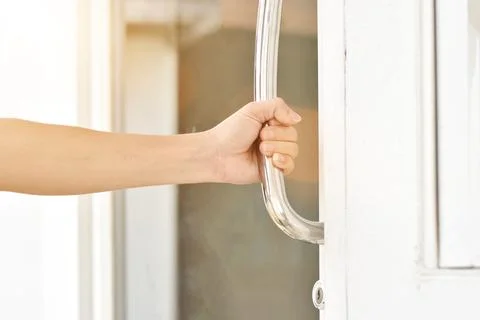 Close-up of man hand open the door holding handle. Photos