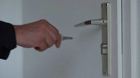Close up to man hand open with key opening white door 4k Stock Footage 46213789