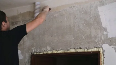 Close up man hand paints the plastered wall Stock Footage 83871851
