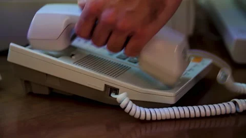 Close up of man hand picks up the white phone and pressing the button. Media Stock Footage 145595231