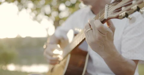 Close Up man hand playing acoustic guitar. Practice holding guitar chords. Music Video stock 166906493