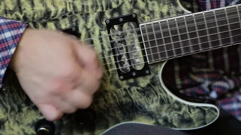 Close up of man hand playing electric guitar. Video stock 77084236