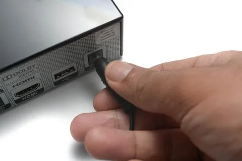 Close up a man hand is plug in the audio cable into its port  Stock Photos