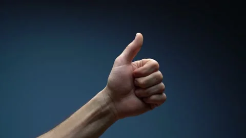 Close up of man hand pointing to the left side showing thumb up sign isolated on Stock Footage 151275488