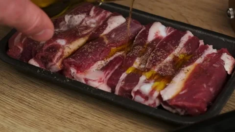 Close up of man hand pouring meat with olive oil sauce Stock Footage 239661819