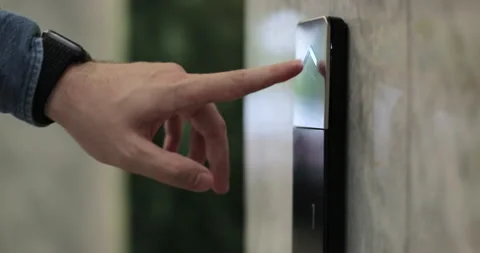 Close-up of man hand presses the elevator call button. Elevator door control Stock Footage 314496540