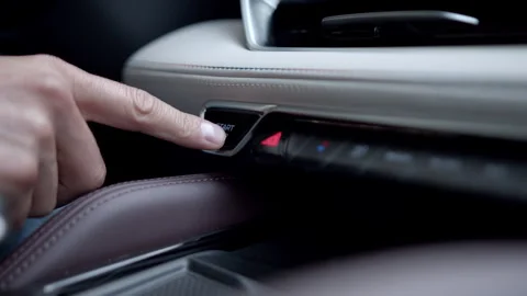 Close up man hand presses engine start or stop button in luxury expensive car Stock Footage 260696394