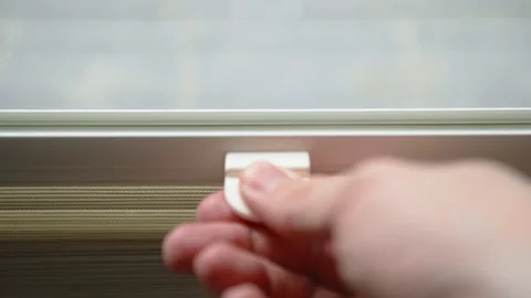 Close-up of man hand pulling up pleated window blind in modern interior Stock-Footage 332021867