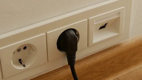 Close up of man hand putting plug off electricity socket Stock Footage 74655956