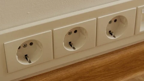 Close up of man hand putting plug in electricity socket Stock Footage 74655992