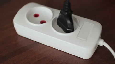 Close up of man hand putting plug in electricity socket to charge Stock Footage 101337357