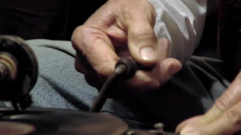 Close Up of Man Hand Releasing Crank and Starting Vintage Gramophone - 4K Stock Footage 336685657