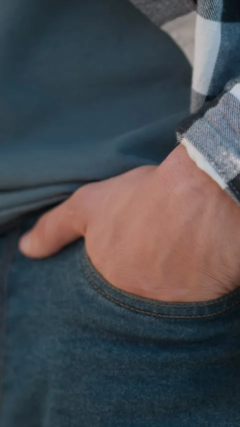 Close up of man hand resting in blue jeans pocket with visible stitching and Stock Footage 345053308