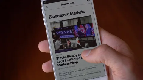 Close up of a Man Hand scrolling BloomBerg Site on a Smartphone in Italy on 8 Stock Footage 90920577