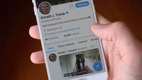Close up of a Man Hand scrolling Donald Trump Facebook Page on a Smartphone in Stock Footage 90920855