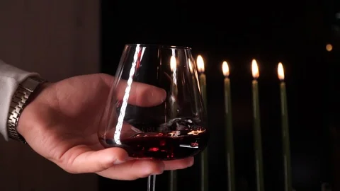 Close up man hand stirring red wine in glass before tasting.Food wine Stock Footage 121312658