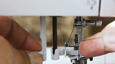 Close up of man hand threading thread into needle of sewing machine Vídeo Stock 108177757