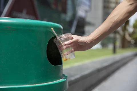 Close up man hand throwing empty plastic bottle drop in recycling bin , Sav.. Stock Photos