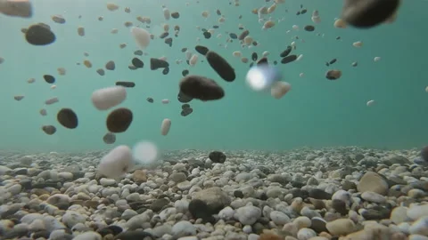 Close up of man hand throwing stones to the sea water. Stock Footage 137263816