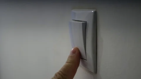 Close Up Man Hand Turning On the Light from a Wall Switch in Office Room Stock-Footage 111144972