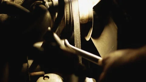 Close up Man hand twists nut of the engine at night under lamp light Video stock 131406314