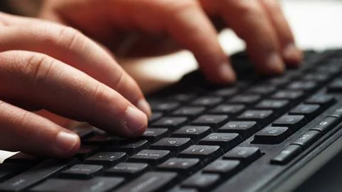 Close up man hand typing on computer keyboard 库存照片