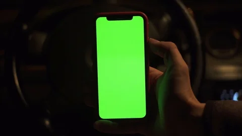 Close up man hand use vertical green screen in background dark blurred view in Stock Footage 118472769