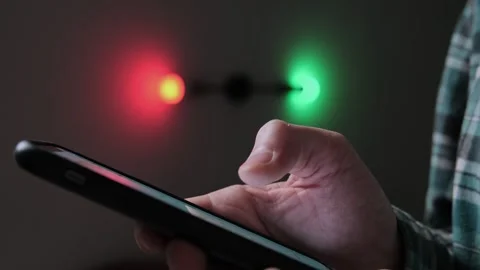 Close-up of man hand uses a smartphone to control smart home features in a dark  Vídeo Stock 296900607
