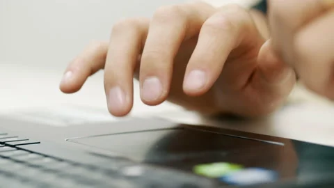 Close-up of man hand uses the touchpad on a laptop, moves with a finger Stock Footage 138140521