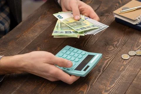 Close up man hand using calculator and writing make note with calculate abo.. Stock-Fotos