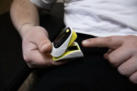 Close up of man hand using pulse oximeter Stock Photos