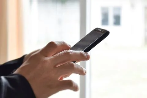 Close up of man hand using smartphone. Idea for business, online banking, tec Stock Photos