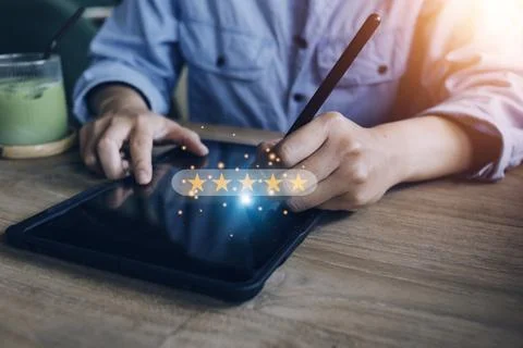 Close up Man hand using smartphone with popup five star icon for feedback r.. Stock Photos
