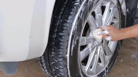 Close up man hand washing wheel car Stock Footage 114350096