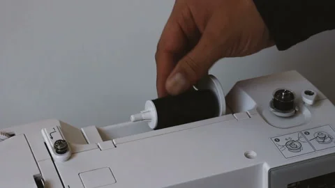 Close up of man hand winding thread on coil of sewing machine Vídeo Stock 108176213