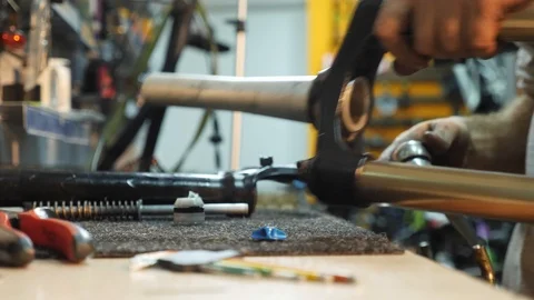 Close-up of man hands adjusting a mountain bike in his workshop. Stock Footage 86468347