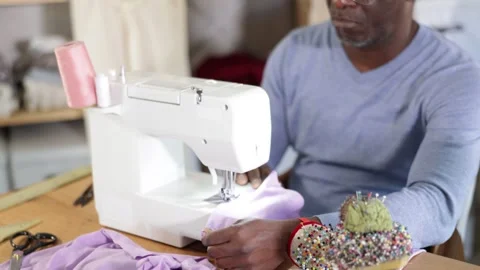 Close up of man hands and sewing machine - process of making clothes Stock Footage 341428414