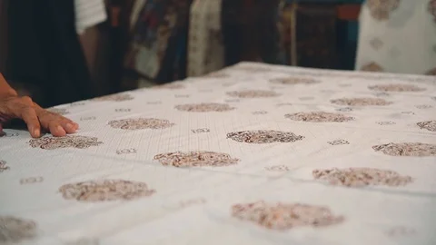 Close up man hands applying wax to make batik Stock Footage 90175180