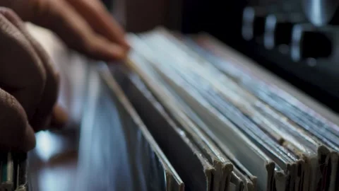 Close up man hands browsing vintage vinyl records at home. Searching Stock Footage 172509938