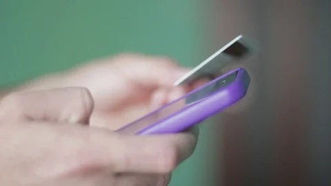 Close up man hands buying goods on smartphone with bank card. Stock Footage 96148224