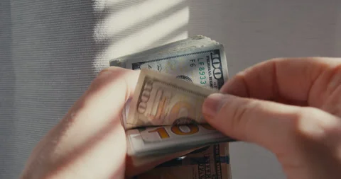 Close-up of man hands counting money 100 dollar bills. Video stock 323133407