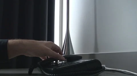 Close up man hands dialing a number on regular phone, tapping the keys, talking Stock Footage 54925488
